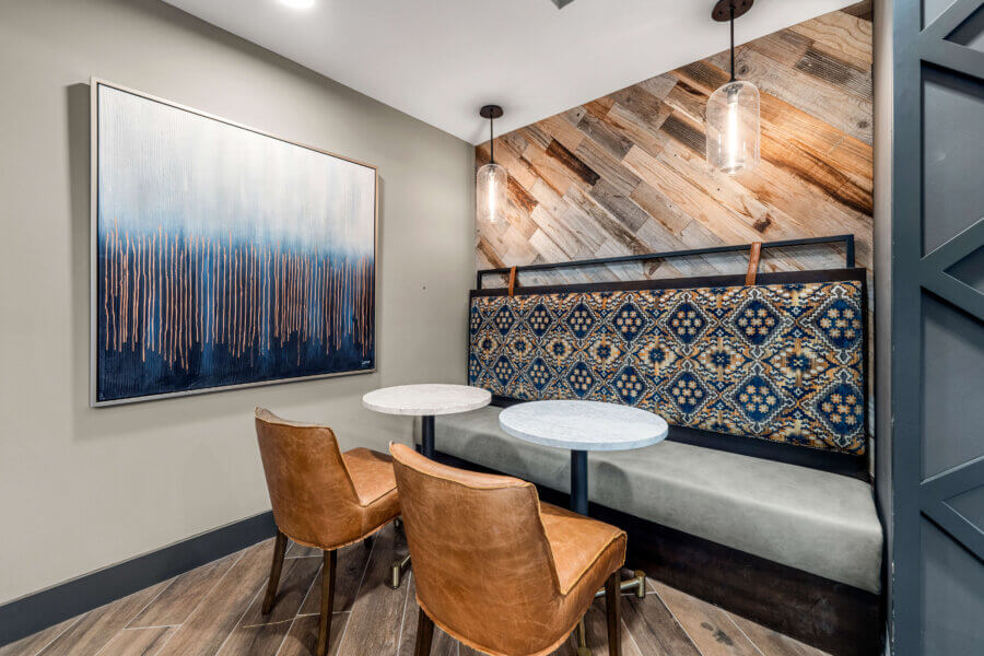 A built-in banquette and leather trimmed chairs provide a stylish seating area in the amenity lounge space