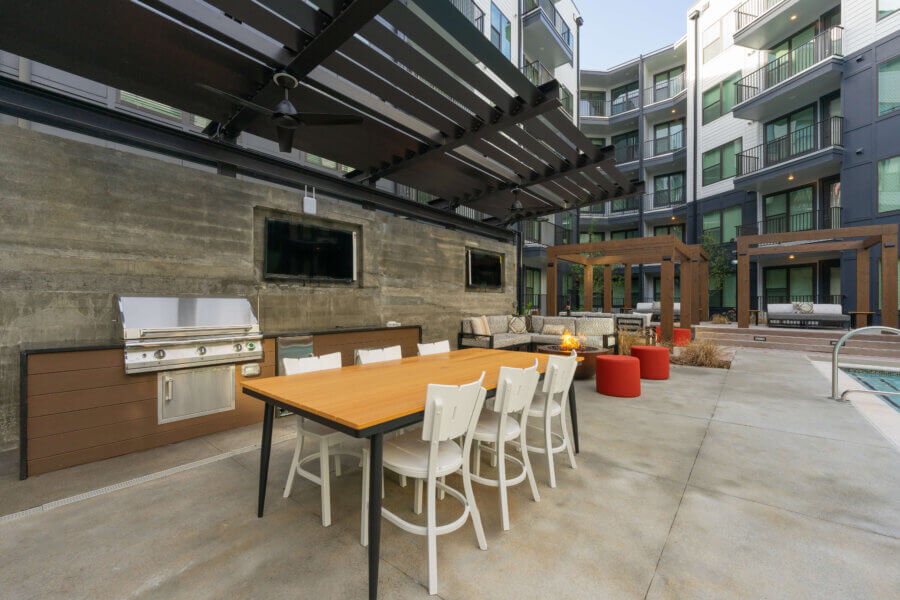 Outdoor amenity areas surrounding the pool area include multiple grilling stations, firepits and personal cabanas